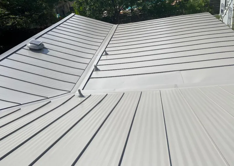 Solar attic fan installed on a metal roof for Roof Ventilation in Green Bay